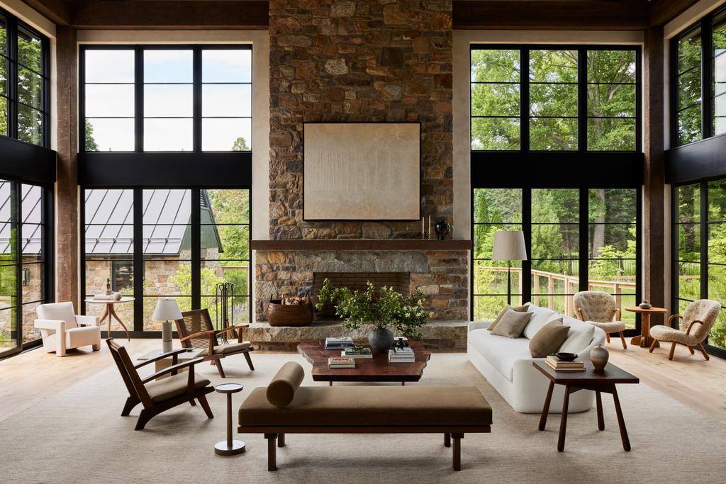 Modern Rugs On A Large Chalet With Large Windows And With A Stone Fireplace And With A Large Sofa And With Wooden Armchairs