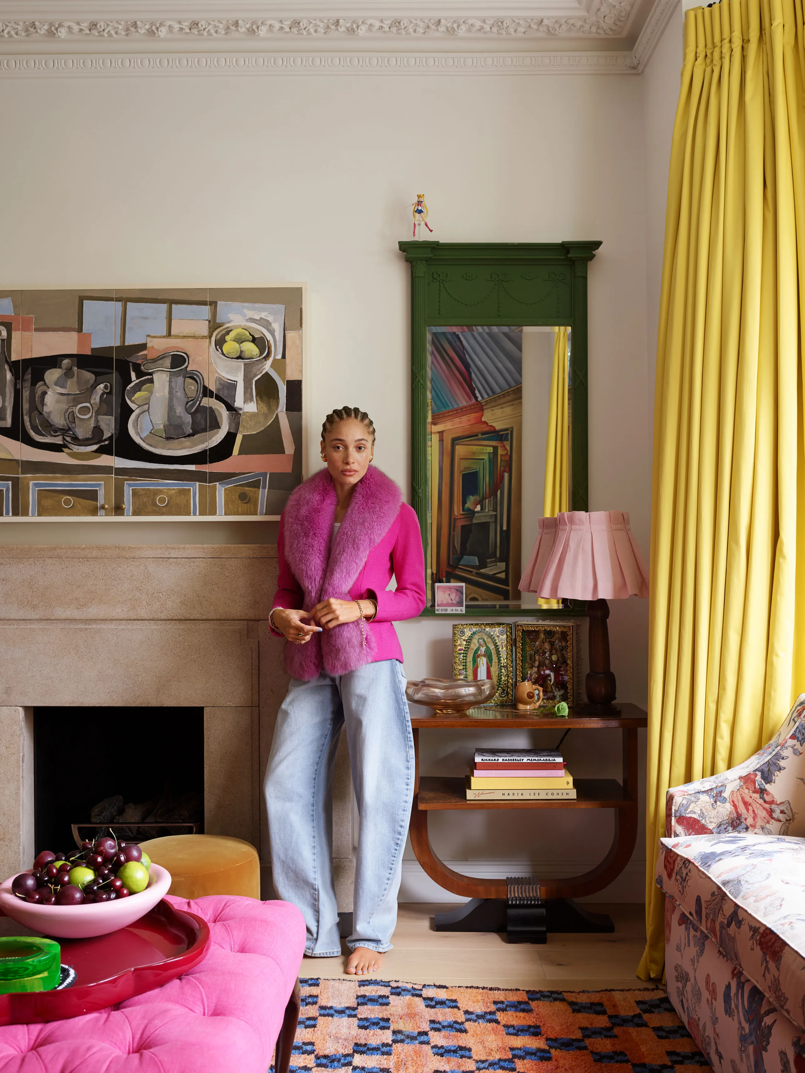 Colorful Home Living Room Of Model Adwoa Aboah With White Walls And With Yellow Curtains And With A Stone Fireplace And With A Magenta Center Table