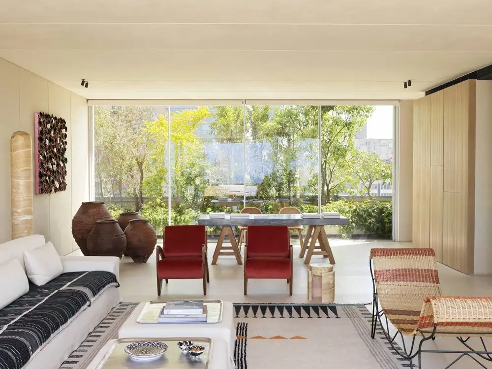 Interior Design Ideas For A Living Room With Large Windows And With Cream Walls And With A White Sofa And With Red Armchairs And With A Textured Rug And With A Bench