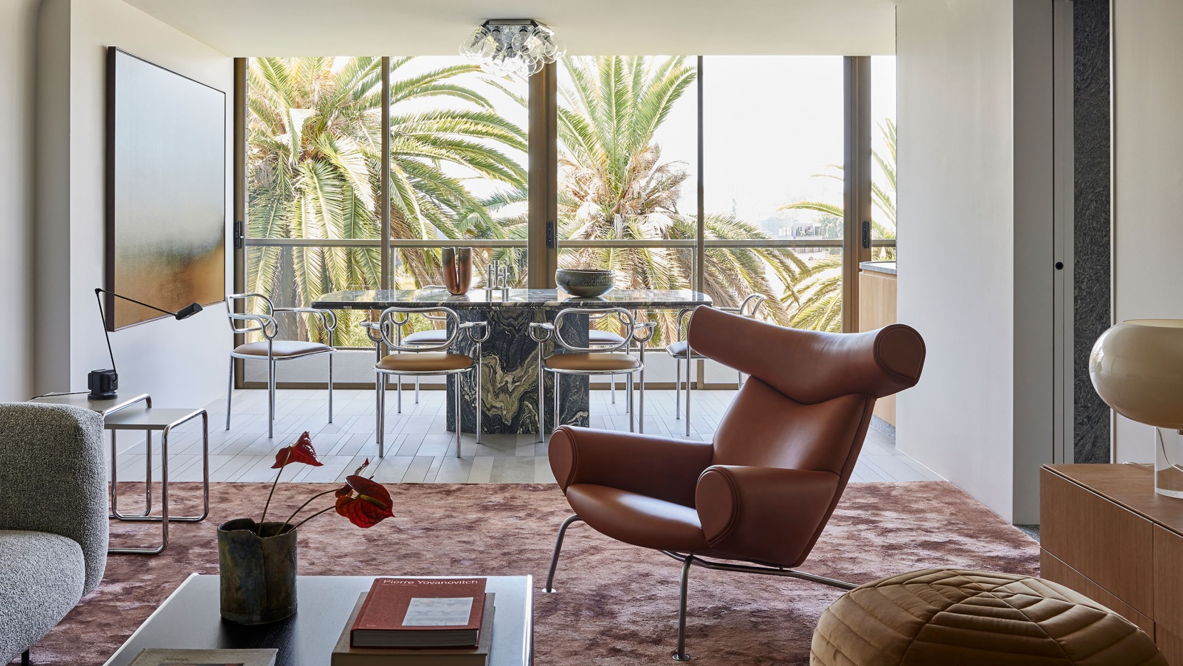 Modern Interior Design Living Room With An Open Space Layout And With Big Windows And With A Brown Armchair